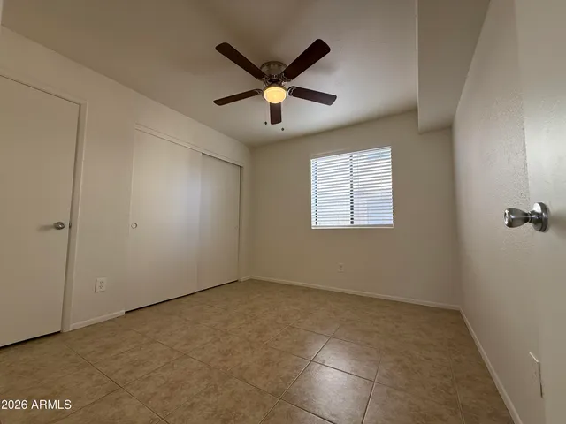 a view of room with ceiling fan and window