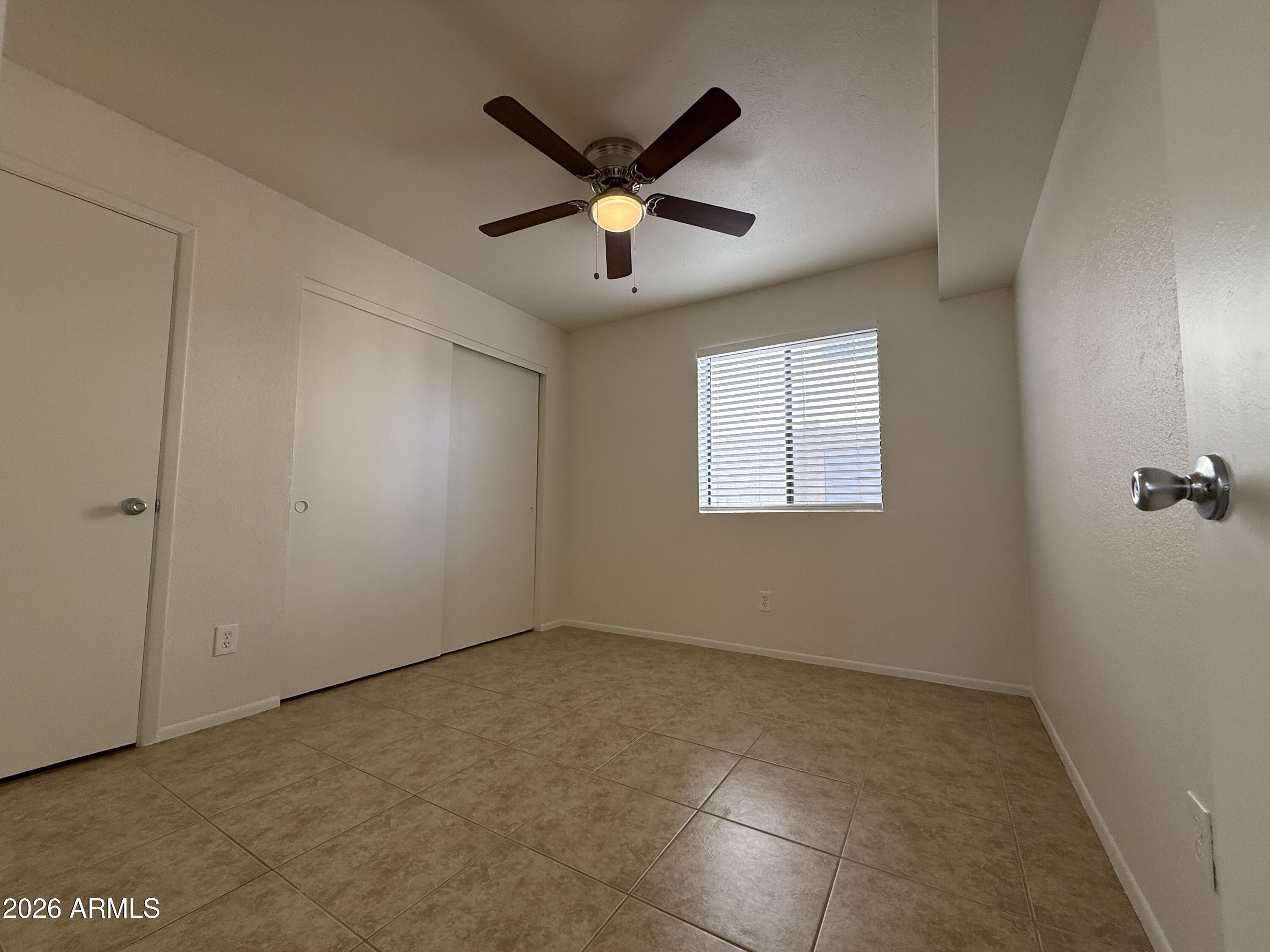 2650 East McKellips Road, Unit 105 Mesa, AZ 85213 - Photo 11 of 13 a view of room with ceiling fan and window