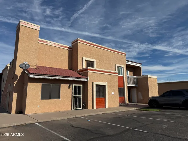 a front view of a house with a parking space