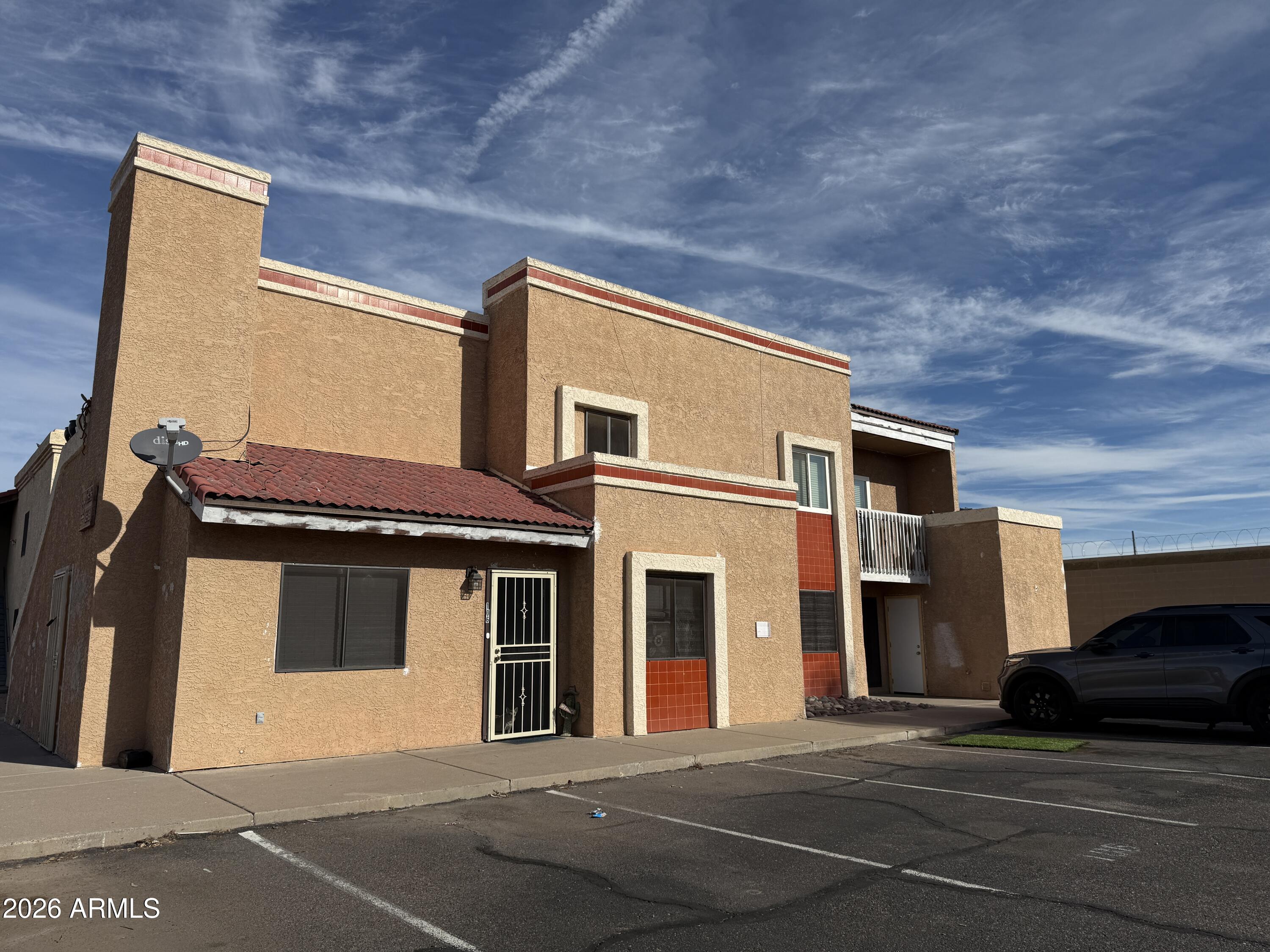 2650 East McKellips Road, Unit 105 Mesa, AZ 85213 - Photo 2 of 13 a front view of a house with a parking space