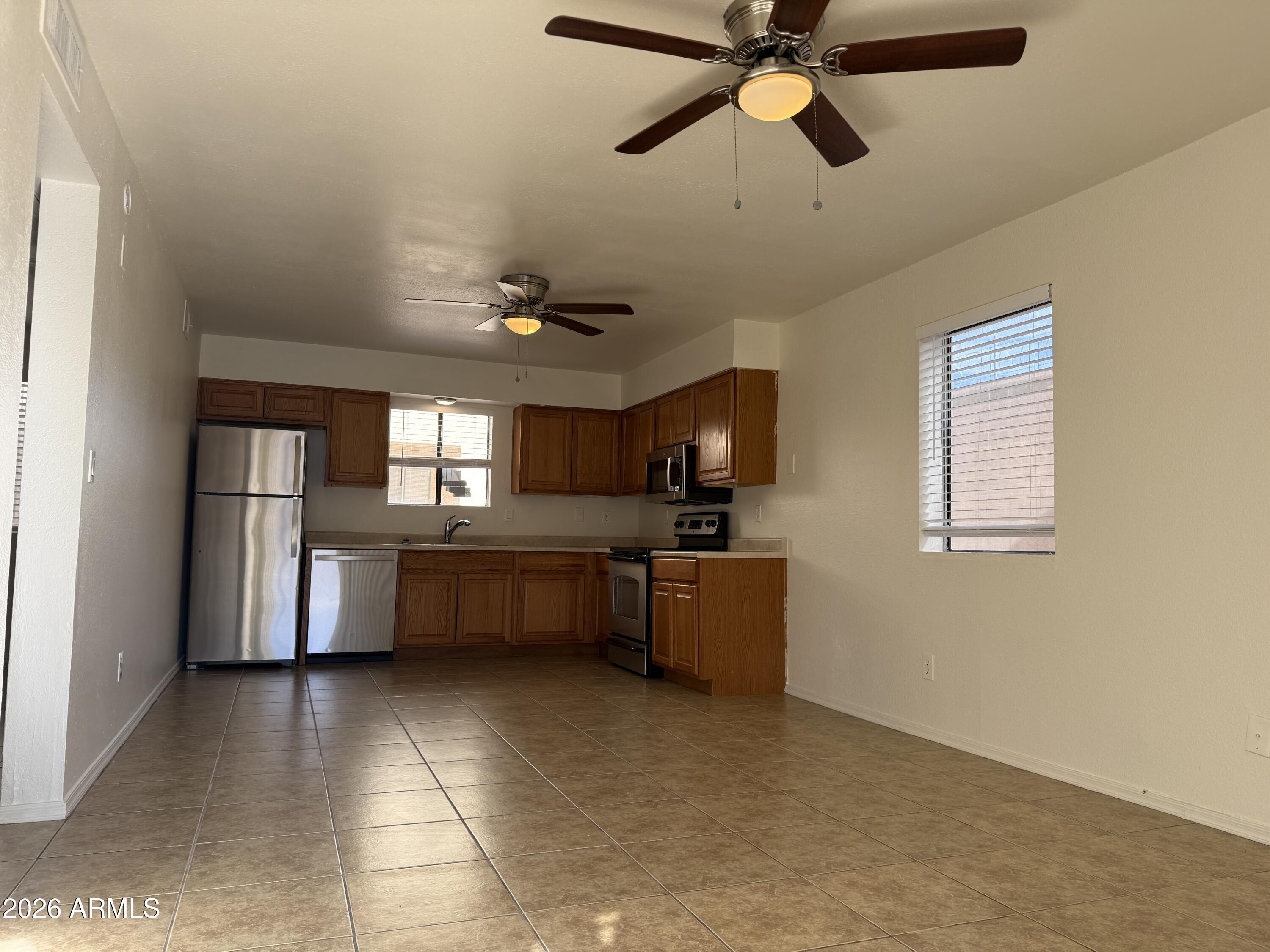 2650 East McKellips Road, Unit 105 Mesa, AZ 85213 - Photo 3 of 13 a kitchen with granite countertop a sink and counter top space