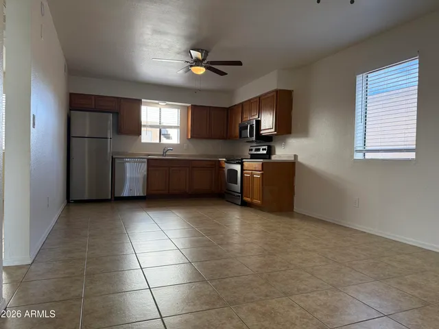 a large kitchen with cabinets and stainless steel appliances