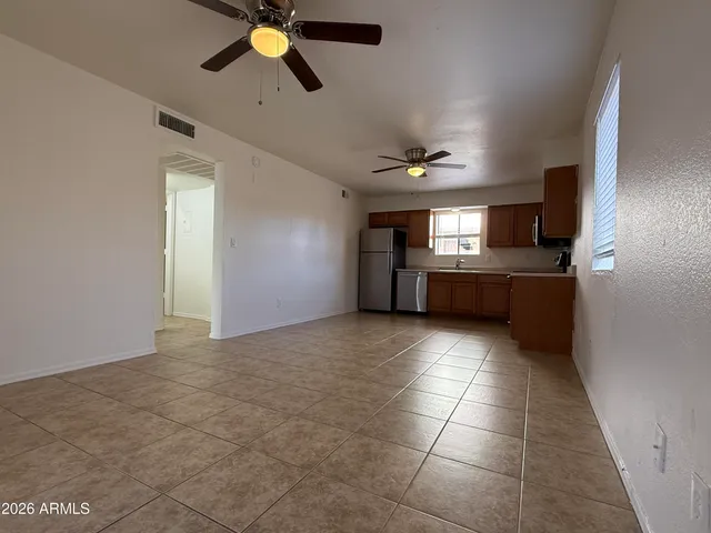 a view of a kitchen with a sink cabinets and stainless steel appliances