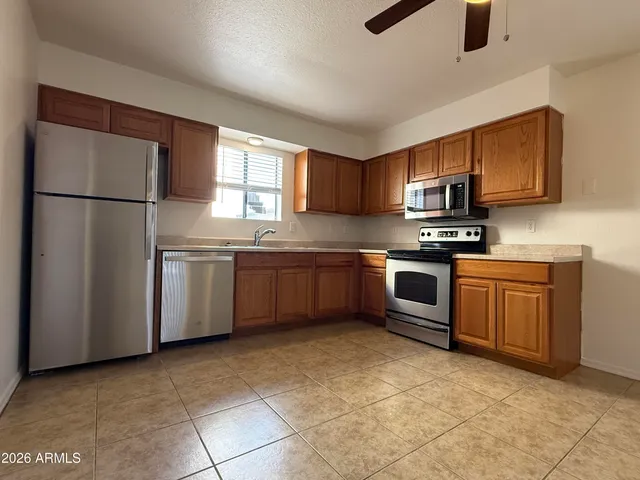 a kitchen with stainless steel appliances granite countertop a stove a sink dishwasher a refrigerator and a microwave oven