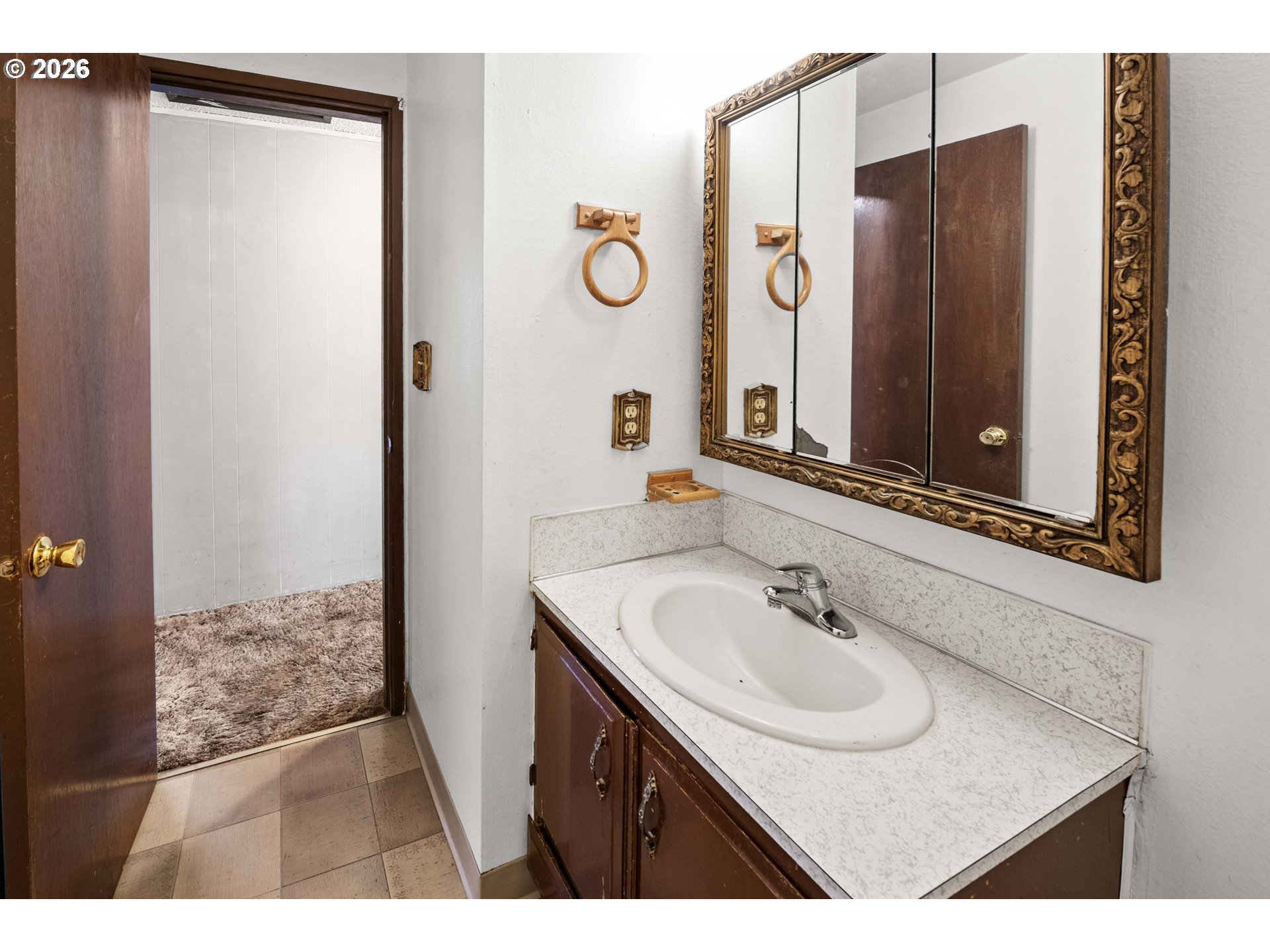 2440 Pine Street Seaside, OR 97138 - Photo 12 of 22 a bathroom with a sink and a mirror