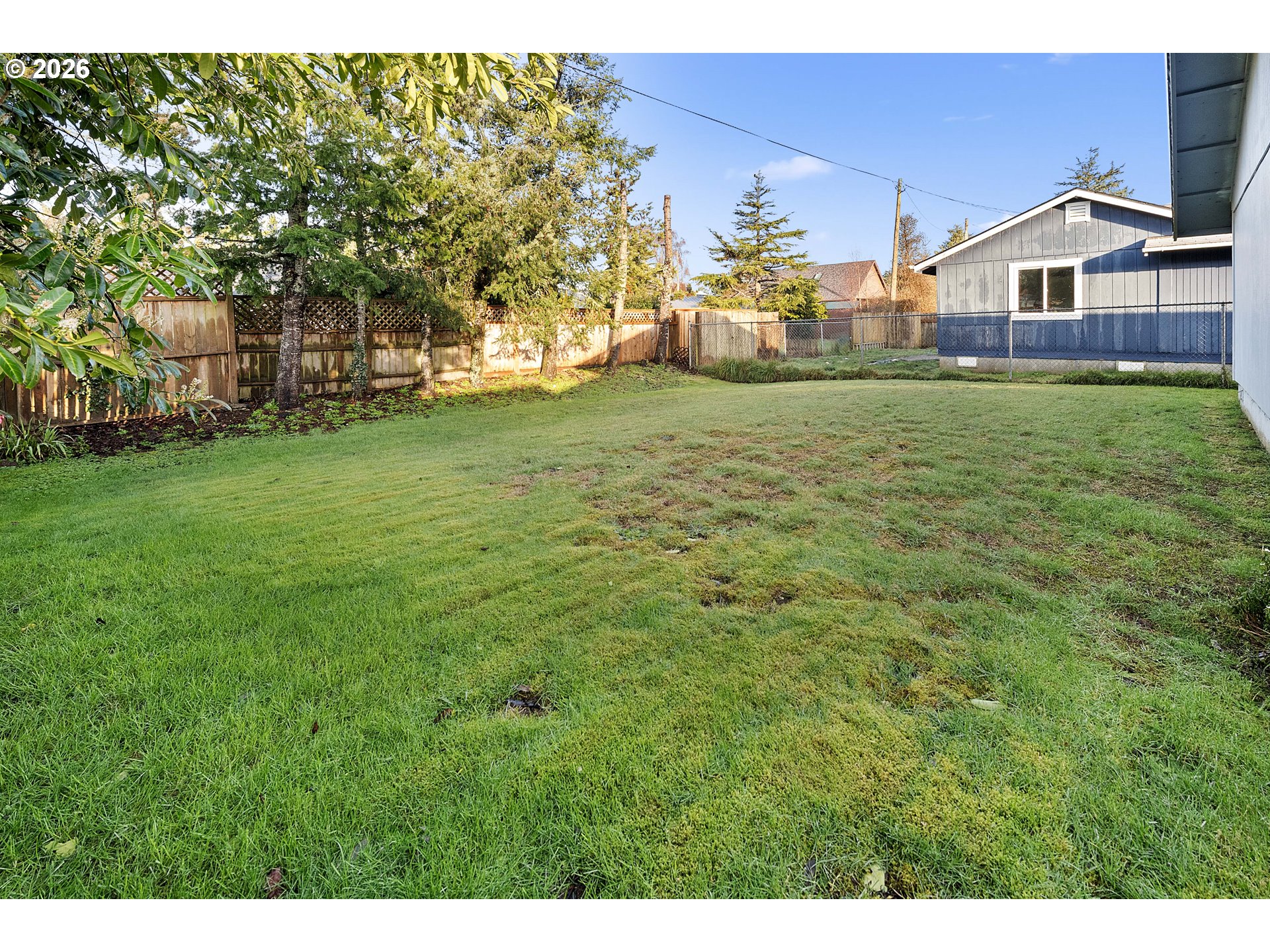 2440 Pine Street Seaside, OR 97138 - Photo 17 of 22 a view of a house with a big yard and large trees