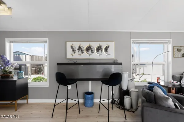 a living room with furniture and a painting on the wall