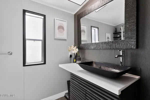 a living room with a sink and a window