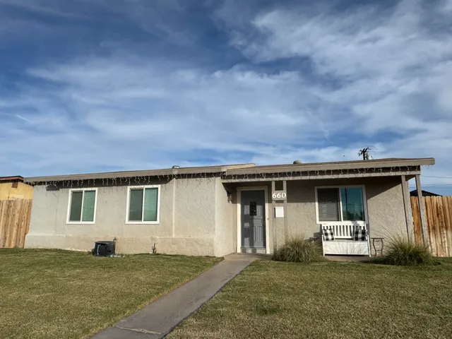 a big house with a big yard and large trees