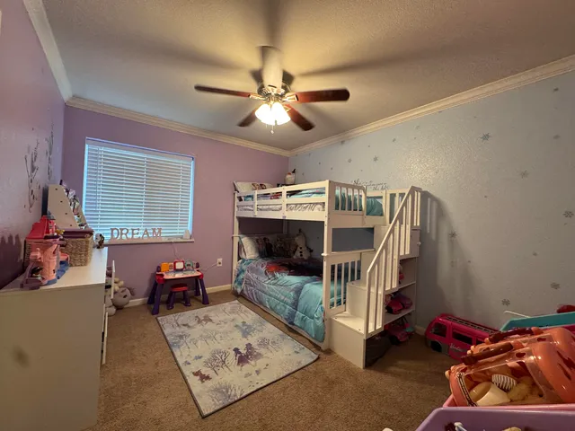 a bedroom with furniture and a baby crib