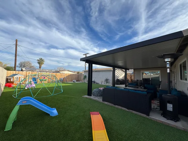 a view of yard with patio