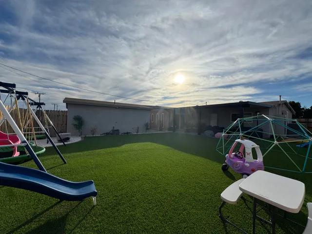 a view of a backyard with furniture and a garage