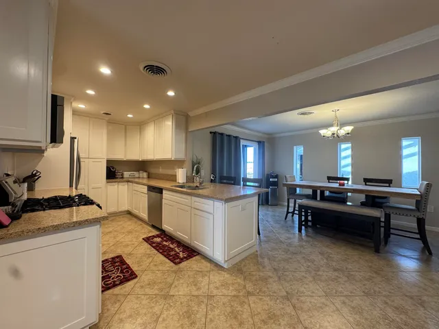 a kitchen with kitchen island granite countertop lots of counter top space
