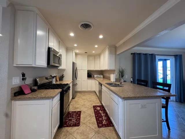 a kitchen with a sink stove and cabinets