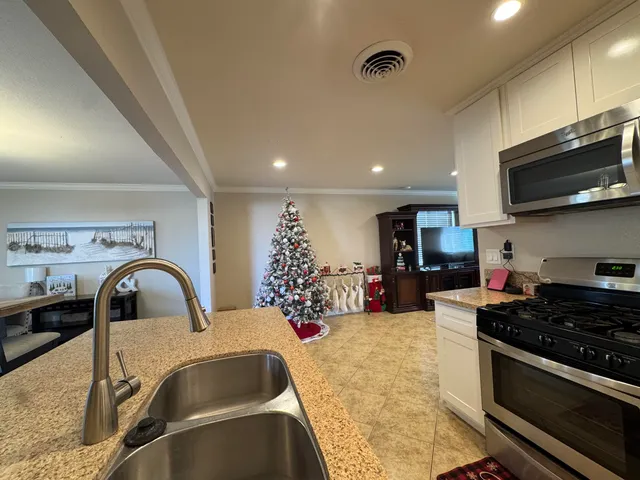 a kitchen with granite countertop a stove and a sink