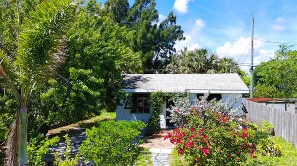 a backyard of a house with lots of green space and fountain