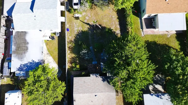 an aerial view of a house with a yard