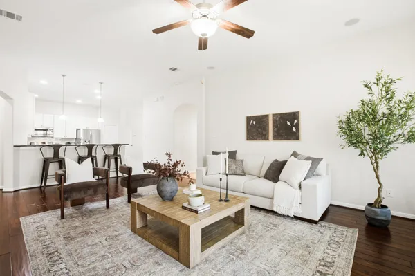a living room with furniture and a potted plant