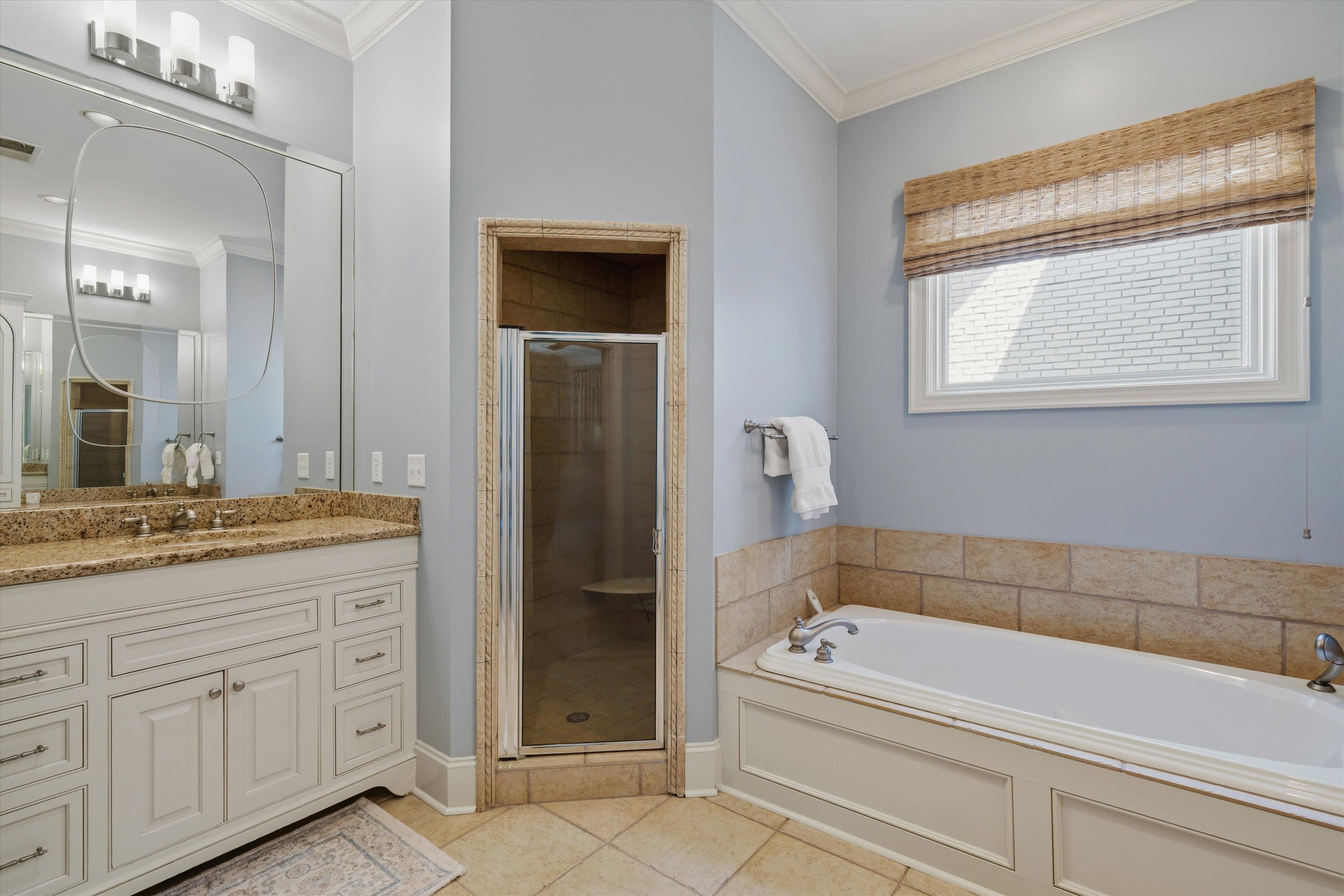 4710 Gwynne Road Memphis, TN 38117 - Photo 22 of 40 a bathroom with a granite countertop sink a bathtub and mirror