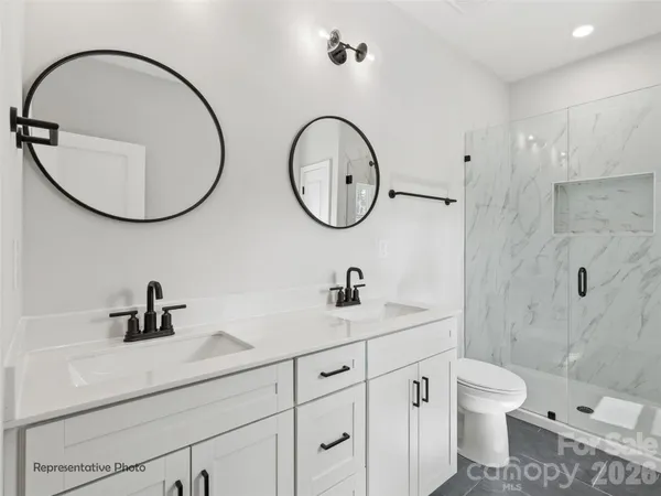 a bathroom with a toilet a sink and a mirror