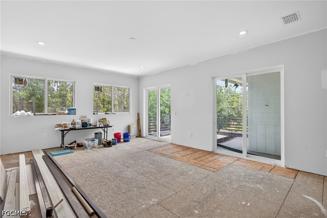 2665 Oil Well Road Naples, FL 34120 - Photo 19 of 40 a bed room with a bed and a chair