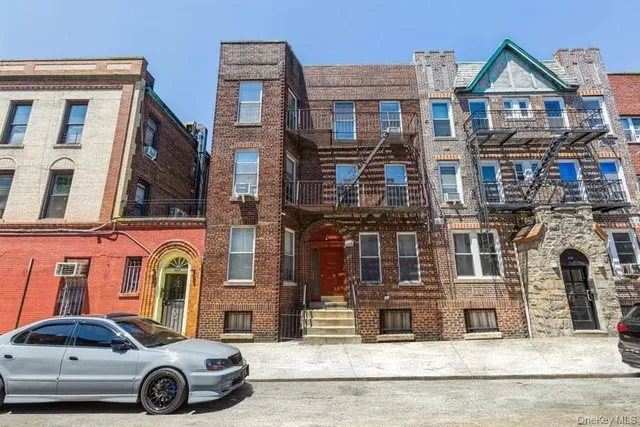 a car parked in front of a brick house