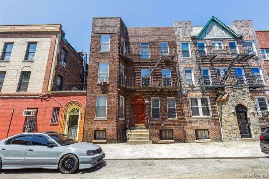 a car parked in front of a brick house