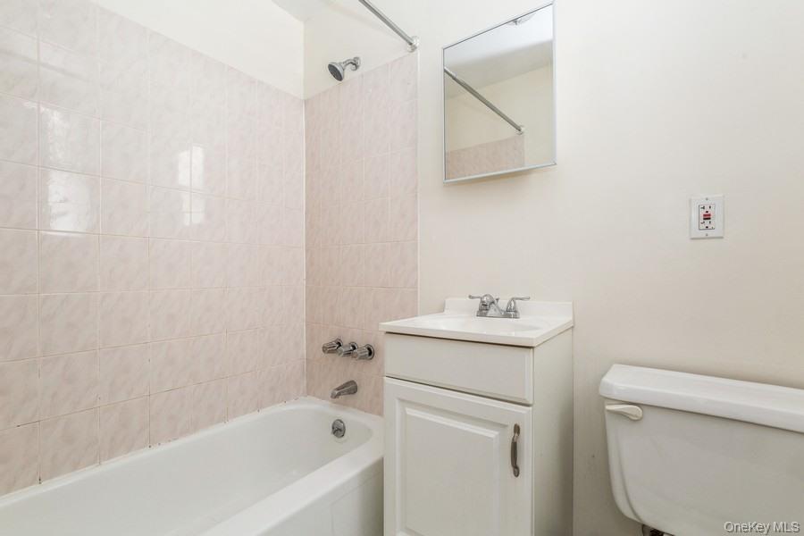 41-32 53rd Street Queens, NY 11377 - Photo 11 of 24 a bathroom with a sink a toilet and shower