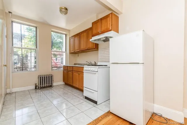 a kitchen with a cabinets and white appliances