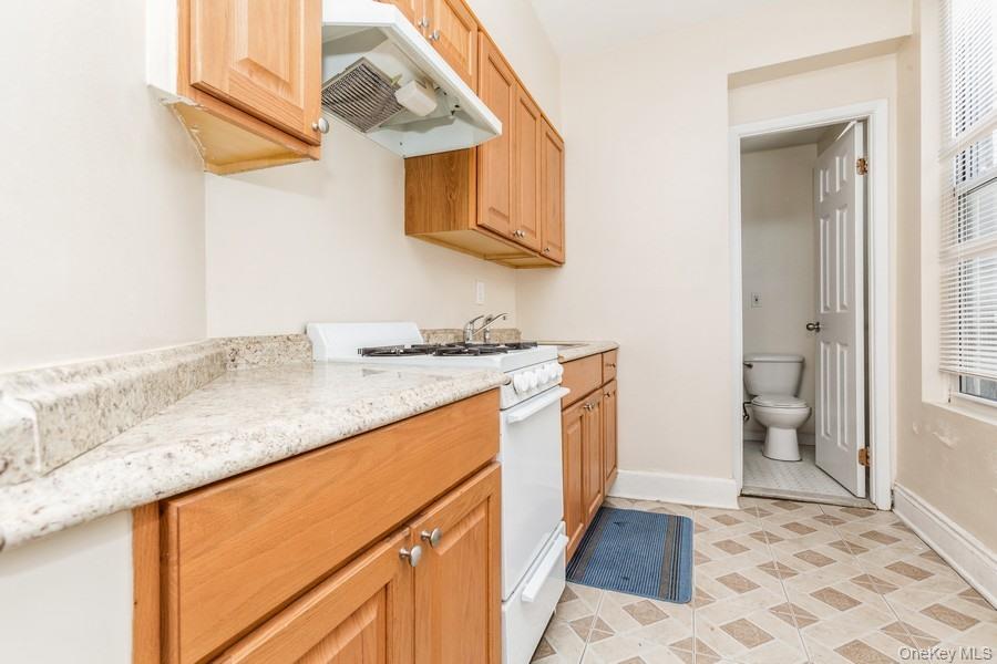 41-32 53rd Street Queens, NY 11377 - Photo 17 of 24 a bathroom with a granite countertop sink and a mirror