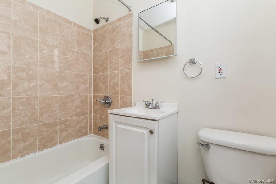 41-32 53rd Street Queens, NY 11377 - Photo 20 of 24 a bathroom with a sink a toilet and shower