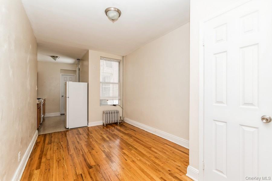 41-32 53rd Street Queens, NY 11377 - Photo 9 of 24 a view of empty room with wooden floor