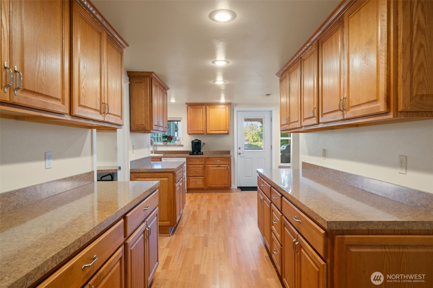 5026 Chico Way Northwest Bremerton, WA 98312 - Photo 11 of 36 a kitchen with granite countertop wooden cabinets a sink and dishwasher