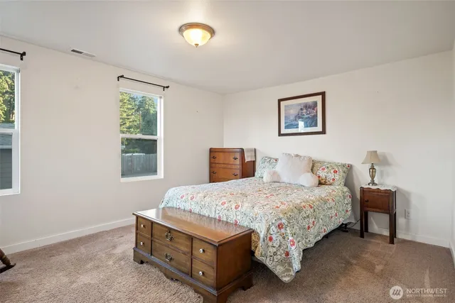 a spacious bedroom with a bed and window