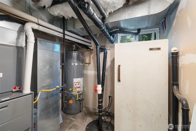 a view of a roof deck with table and chairs under wooden roof with potted plants