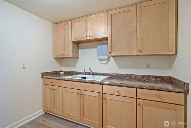 a view of backyard of house with wooden fence