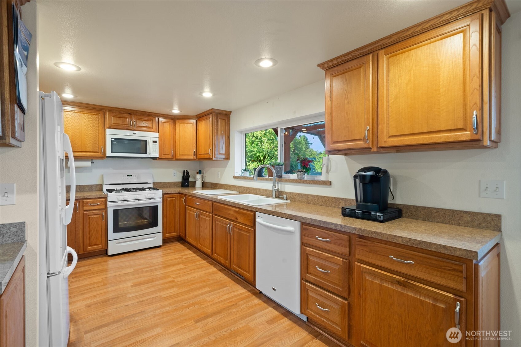 5026 Chico Way Northwest Bremerton, WA 98312 - Photo 9 of 36 a kitchen with stainless steel appliances granite countertop a stove a sink and a microwave