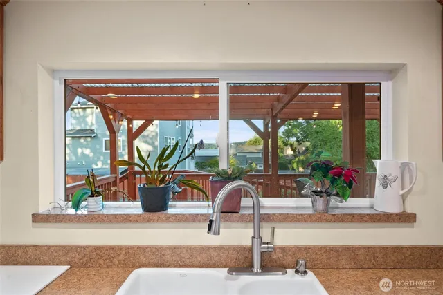 a kitchen with granite countertop wooden cabinets a sink and dishwasher