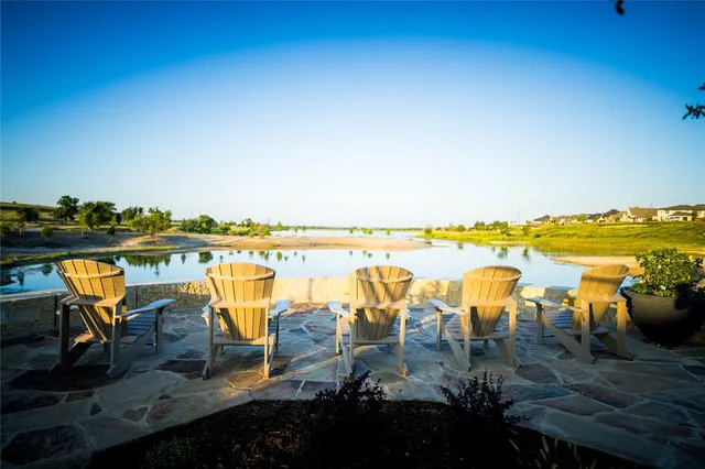 a view of a patio with table and chairs and potted plants