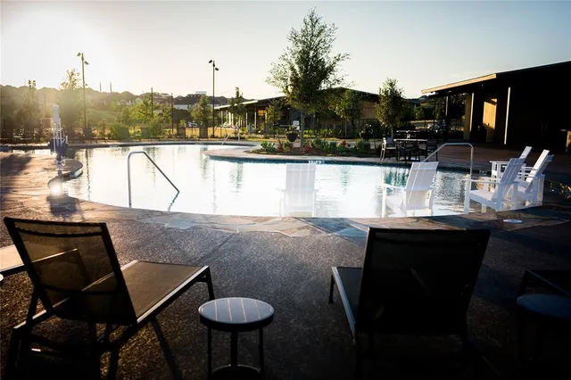 a kitchen with a table chairs stove and cabinets
