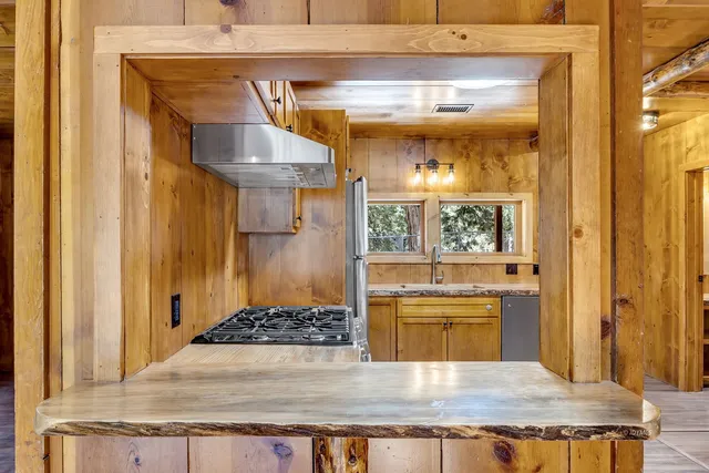 a kitchen with granite countertop a sink and a stove