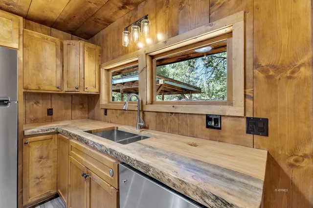 a kitchen with a sink a counter top space and cabinets