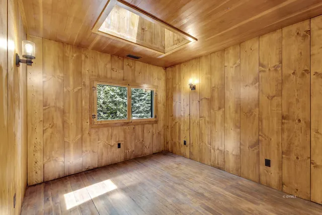 a view of a hallway with wooden door