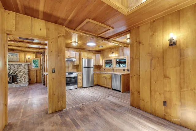 a view of a kitchen with furniture and wooden floor