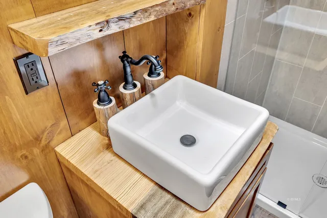 a white toilet sitting next to a bathroom sink