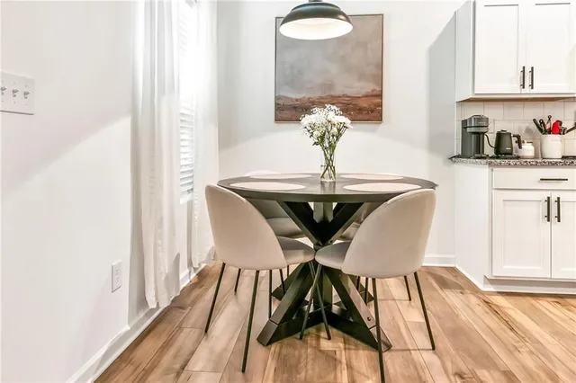 a view of a dining room with furniture and wooden floor