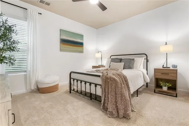 a bedroom with a bed and a window