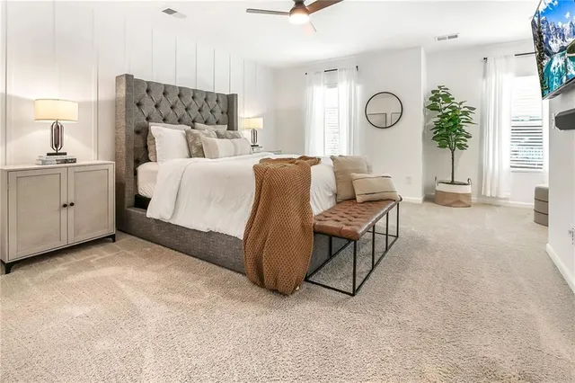 a bedroom with a bed and a chandelier