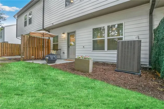 a view of a house with backyard and sitting area