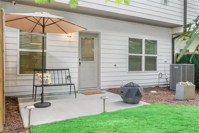 a view of a house with backyard porch and sitting area